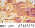 Turquoise brown abstract background with orange red hues. A weathered rust-eaten textured sheet of metal with traces of paint residue. 87882576