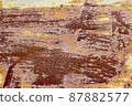 Red brown abstract background with pink and turquoise hues. A weathered, rust-eaten textured sheet of metal with traces of paint residue. 87882577