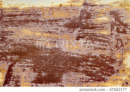 Red brown abstract background with pink and turquoise hues. A weathered, rust-eaten textured sheet of metal with traces of paint residue. Red brown abstract background with pink and turquoise hues. A weathered, rust-eaten textured sheet of metal with traces of paint residue. 87882577