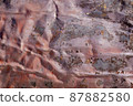 Dark pink abstract background with silver grey brown red and purple hues. A weathered, rust-eaten, crumpled textured sheet of metal. 87882580