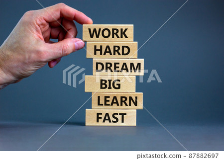 Work hard dream big symbol. Words Work hard dream big learn fast on wooden blocks on a beautiful grey background. Businessman hand. Business, motivational and work hard dream big learn fast concept. Work hard dream big symbol. Words Work hard dream big learn fast on wooden blocks on a beautiful grey background. Businessman hand. Business, motivational and work hard dream big learn fast concept. 87882697
