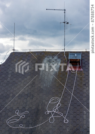 The rope pulled from the skylight lies on the roof with antenna The rope pulled from the skylight lies on the roof with antenna 87888754