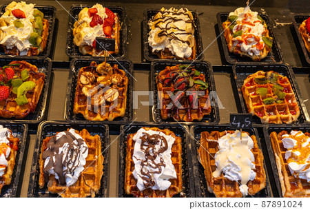 Belgian waffles with colorful toppings on showcase. Brussels 87891024