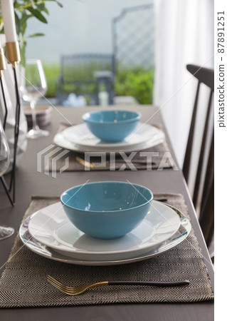 Modern dinning room interior with blue plate on wood table at home. Modern dinning room interior with blue plate on wood table at home. 87891251