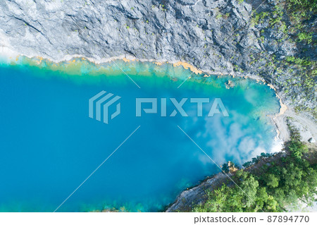 Aerial view of amazing pond in tropical rainforest forest with mountain rocks peak Beautiful water surface in Phang Nga Thailand 87894770