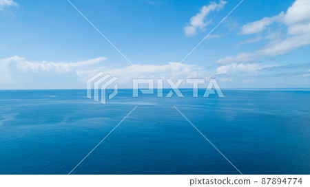 Aerial view of a blue sea surface water texture background and sun reflections Aerial flying drone view Waves water surface texture on sunny tropical ocean in Phuket island Thailand 87894774