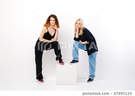 Two girls in white studio 87895124