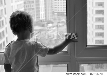 Beautiful baby boy with child face posing photographer near window Beautiful baby boy with child face posing photographer near window 87896709