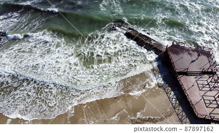 Aerial Drone View Flight Over Old Breakwater on Sandy Beach. Top View Waves 87897162