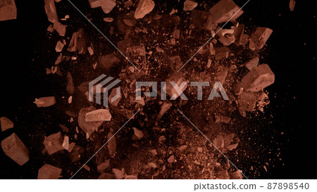 Freeze motion of flying group of raw chocolate pieces. Freeze motion of flying group of raw chocolate pieces. 87898540