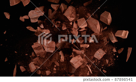 Freeze motion of flying group of raw chocolate pieces. Freeze motion of flying group of raw chocolate pieces. 87898541