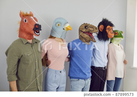 Team of happy crazy people wearing different funny bizarre eccentric carnival animal masks standing in row and hugging each other. Teamwork, unity, cooperation, fun, friendship concepts Team of happy crazy people wearing different funny bizarre eccentric carnival animal masks standing in row and hugging each other. Teamwork, unity, cooperation, fun, friendship concepts 87899573