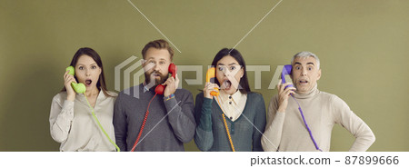 People get bad news over phone call. Four people of different ages and generations standing on green studio background and holding old retro telephone receivers with surprised shocked face expressions 87899666