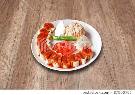 Beyti Kebab and vegetables on wooden table 87900795