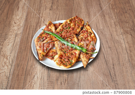 Beef Pide and vegetables on wooden table 87900808