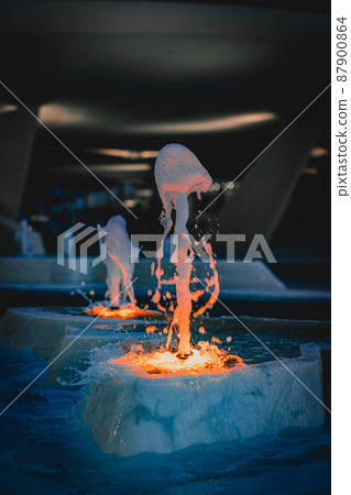 close up shot of city fountain with blue and orange lights, Cyprus 87900864