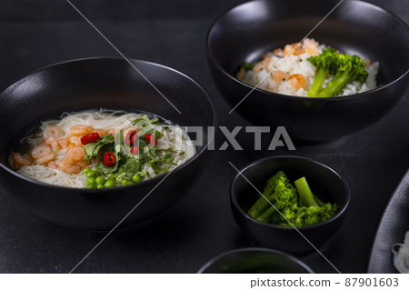 Various dishes of Asian cuisine with different types noodles and rice with shrimp, duck, vegetables and black sesame Various dishes of Asian cuisine with different types noodles and rice with shrimp, duck, vegetables and black sesame 87901603