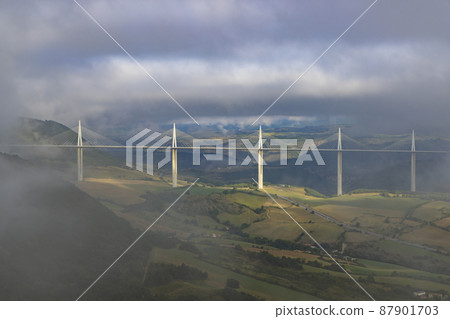 Multi-span cable stayed Millau Viaduct across gorge valley of Tarn River, Aveyron Departement, France Multi-span cable stayed Millau Viaduct across gorge valley of Tarn River, Aveyron Departement, France 87901703