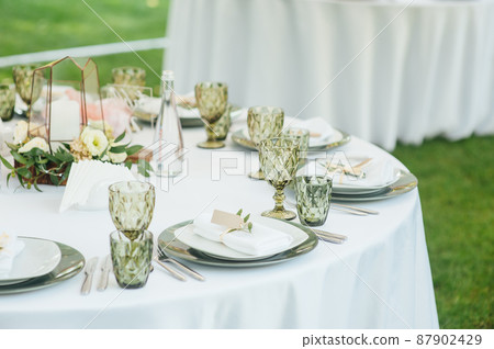 Wedding. Banquet. The chairs and round table for guests, served with cutlery. Wedding. Banquet. The chairs and round table for guests, served with cutlery. 87902429