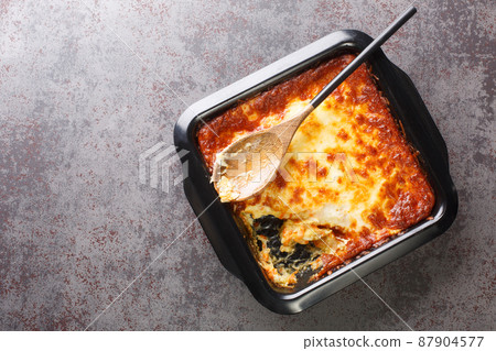 Portuguese casserole Bacalhau espiritual delicious cod cooked with onion, grated carrots sprinkled with grated cheese closeup. Horizontal top view 87904577