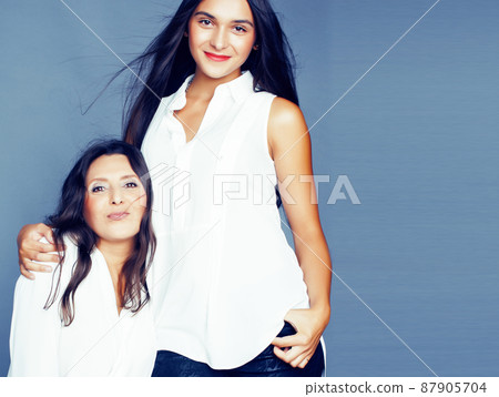 cute pretty teen daughter with mature mother hugging, fashion style brunette, lifestyle people concept cute pretty teen daughter with mature mother hugging, fashion style brunette, lifestyle people concept 87905704