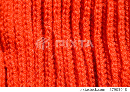 Handmade knitted fabric orange wool background texture 87905948