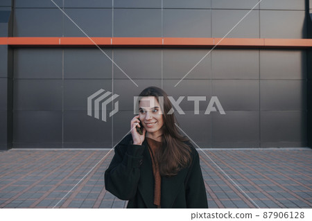 brunette cute girl talking by the phone brunette cute girl talking by the phone 87906128