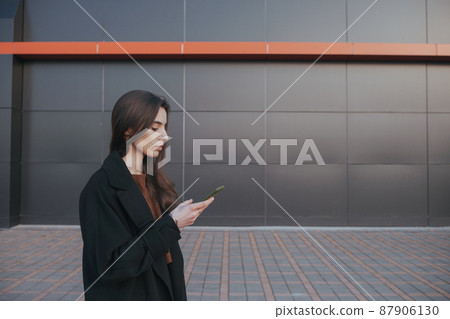 brunette cute girl talking by the phone brunette cute girl talking by the phone 87906130