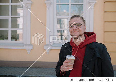 Takeaway coffee is my lifestyle. Handsome man hold coffee cup outdoors. Young guy drink coffee on summer morning. Enjoying coffee 87906183