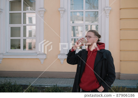Takeaway coffee is my lifestyle. Handsome man hold coffee cup outdoors. Young guy drink coffee on summer morning. Enjoying coffee Takeaway coffee is my lifestyle. Handsome man hold coffee cup outdoors. Young guy drink coffee on summer morning. Enjoying coffee 87906186