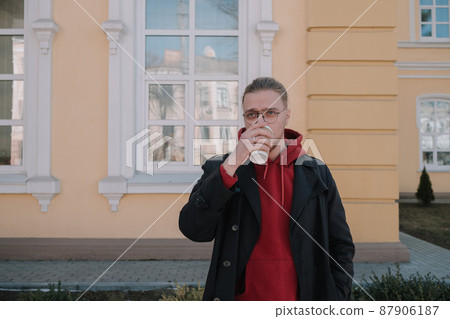 Takeaway coffee is my lifestyle. Handsome man hold coffee cup outdoors. Young guy drink coffee on summer morning. Enjoying coffee Takeaway coffee is my lifestyle. Handsome man hold coffee cup outdoors. Young guy drink coffee on summer morning. Enjoying coffee 87906187