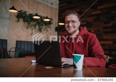 Portrait of happy male freelancer in optical eyewear for vision correction smiling at camera during break from web working online, cheerful hipster blogger sitting in cafe with mockup laptop Portrait of happy male freelancer in optical eyewear for vision correction smiling at camera during break from web working online, cheerful hipster blogger sitting in cafe with mockup laptop 87906200
