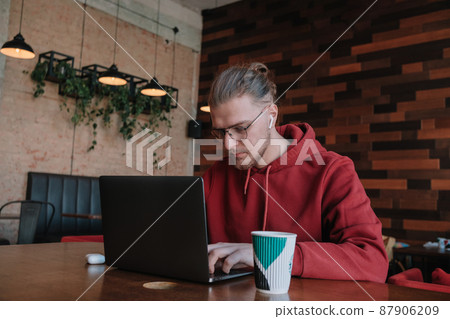Portrait of happy male freelancer in optical eyewear for vision correction smiling at camera during break from web working online, cheerful hipster blogger sitting in cafe with mockup laptop Portrait of happy male freelancer in optical eyewear for vision correction smiling at camera during break from web working online, cheerful hipster blogger sitting in cafe with mockup laptop 87906209
