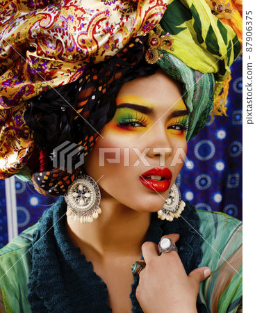 beauty bright african woman with creative make up, shawl on head like cuban woman 87906375