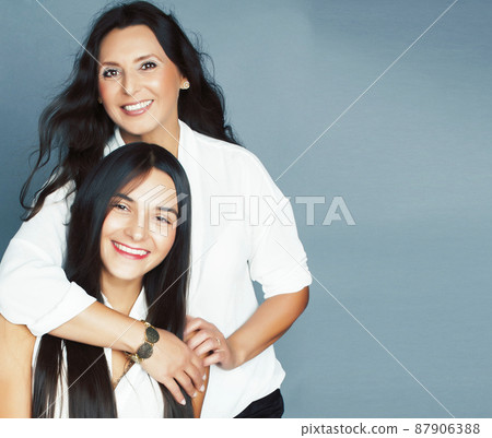 cute pretty teen daughter with mature mother hugging, fashion style brunette, lifestyle people concept cute pretty teen daughter with mature mother hugging, fashion style brunette, lifestyle people concept 87906388
