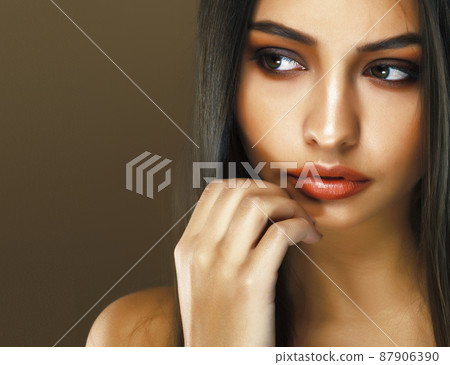 cute happy young indian woman in studio closeup smiling on brown background, fashion beauty lifestyle people concept cute happy young indian woman in studio closeup smiling on brown background, fashion beauty lifestyle people concept 87906390