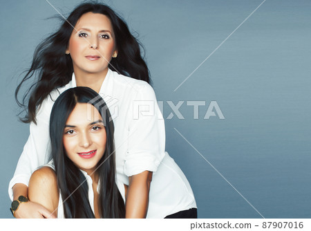 cute pretty teen daughter with mature mother hugging, fashion style brunette, lifestyle people concept cute pretty teen daughter with mature mother hugging, fashion style brunette, lifestyle people concept 87907016