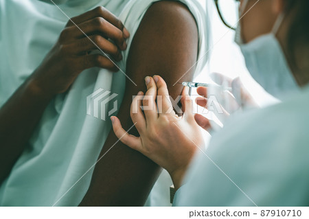 Young man visits skillful doctor at hospital for vaccination Young man visits skillful doctor at hospital for vaccination 87910710