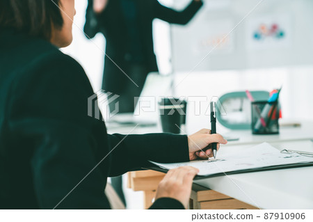 Businesswoman in business meeting writing paper proficiently at office room . Businesswoman in business meeting writing paper proficiently at office room . 87910906