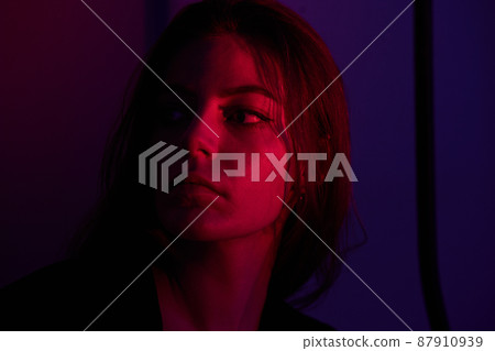 Half-lighted face of girl with blueish and very peri background Half-lighted face of girl with blueish and very peri background 87910939