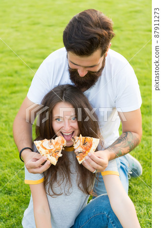 All for her. Fast food. Bearded man feeding woman All for her. Fast food. Bearded man feeding woman 87911273