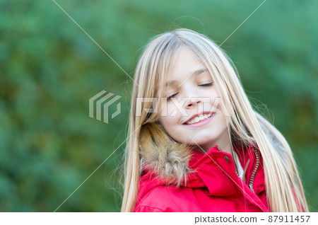 Child with closed eyes enjoy idyllic autumn day 87911457