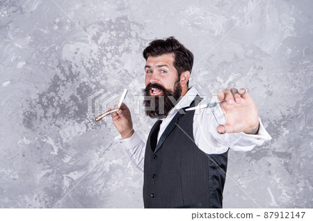 handsome brutal man barber with beard hold barbershop retro razor blade and scissors, hair salon. handsome brutal man barber with beard hold barbershop retro razor blade and scissors, hair salon. 87912147