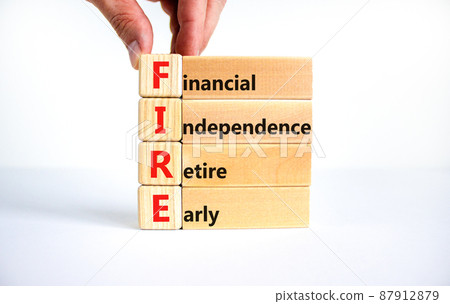 FIRE financial independence retire early symbol. Concept words FIRE financial independence retire early on blocks. White background. Business FIRE financial independence retire early concept. 87912879