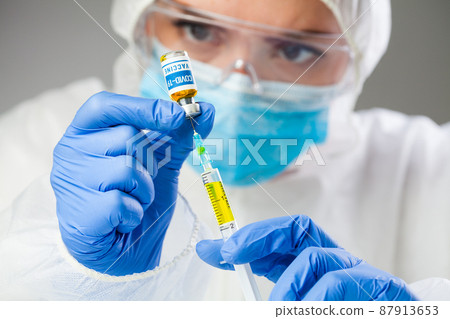 Medical scientist holding sample Coronavirus COVID-19 vaccine Medical scientist holding sample Coronavirus COVID-19 vaccine 87913653
