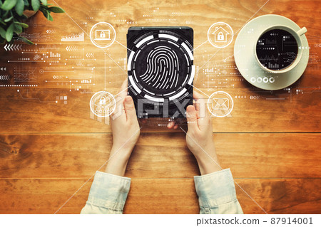 Fingerprint scanning theme with a person holding a tablet Fingerprint scanning theme with a person holding a tablet 87914001