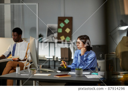 Young Woman Working Late in Evening 87914296
