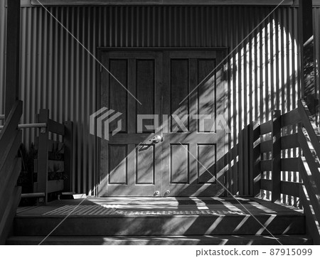 An Entry Door Highlighted By Sunlight 87915099