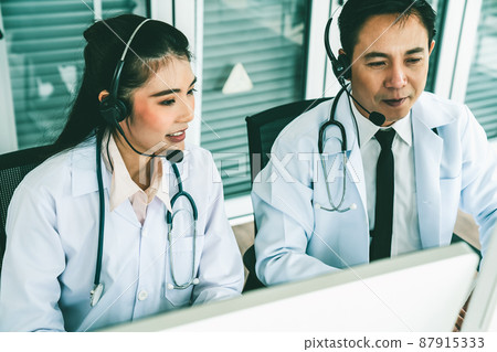 Doctor team wearing headset talking actively on video call in hospital clinic 87915333