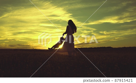 cheerful mother circling little child park sunset. happy family life. travel mom daughter girl sunlight sky. kid baby with parent happy family. silhouette pilot's childhood dream. flying kid air. cheerful mother circling little child park sunset. happy family life. travel mom daughter girl sunlight sky. kid baby with parent happy family. silhouette pilot's childhood dream. flying kid air. 87915421